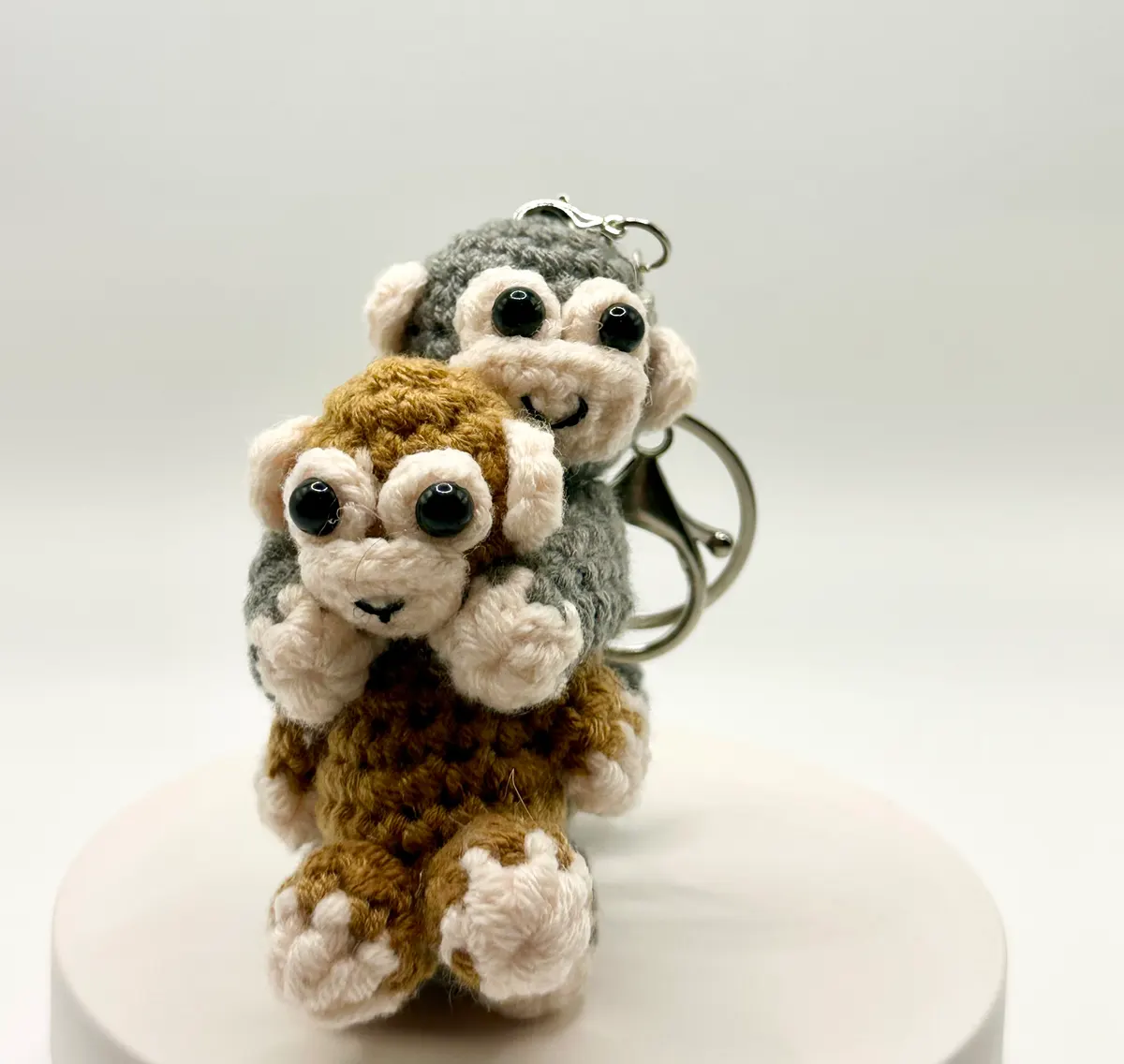 Hugging monkeys charm in Brown and grey