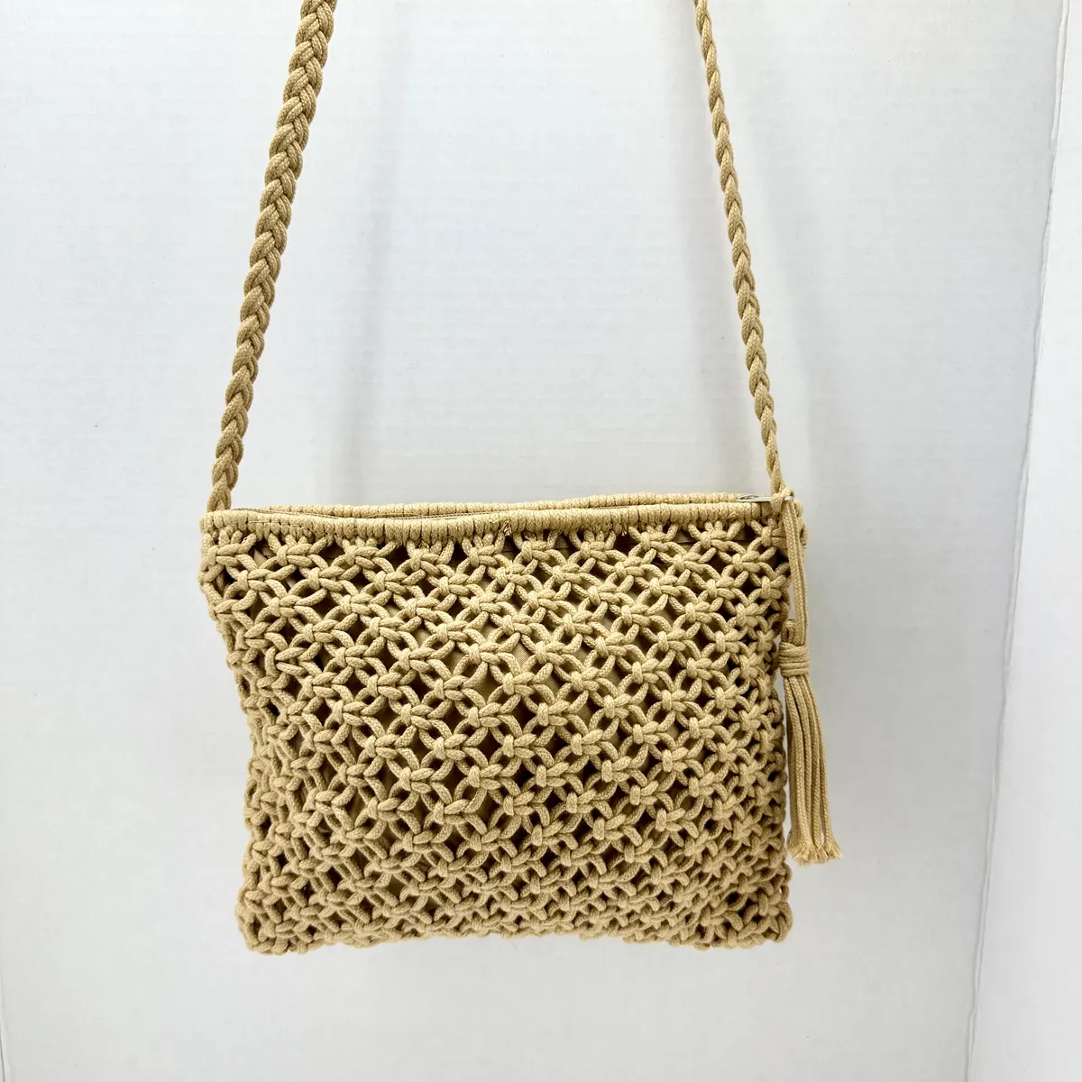 Natural macramé crossbody bag with a braided strap and tassel