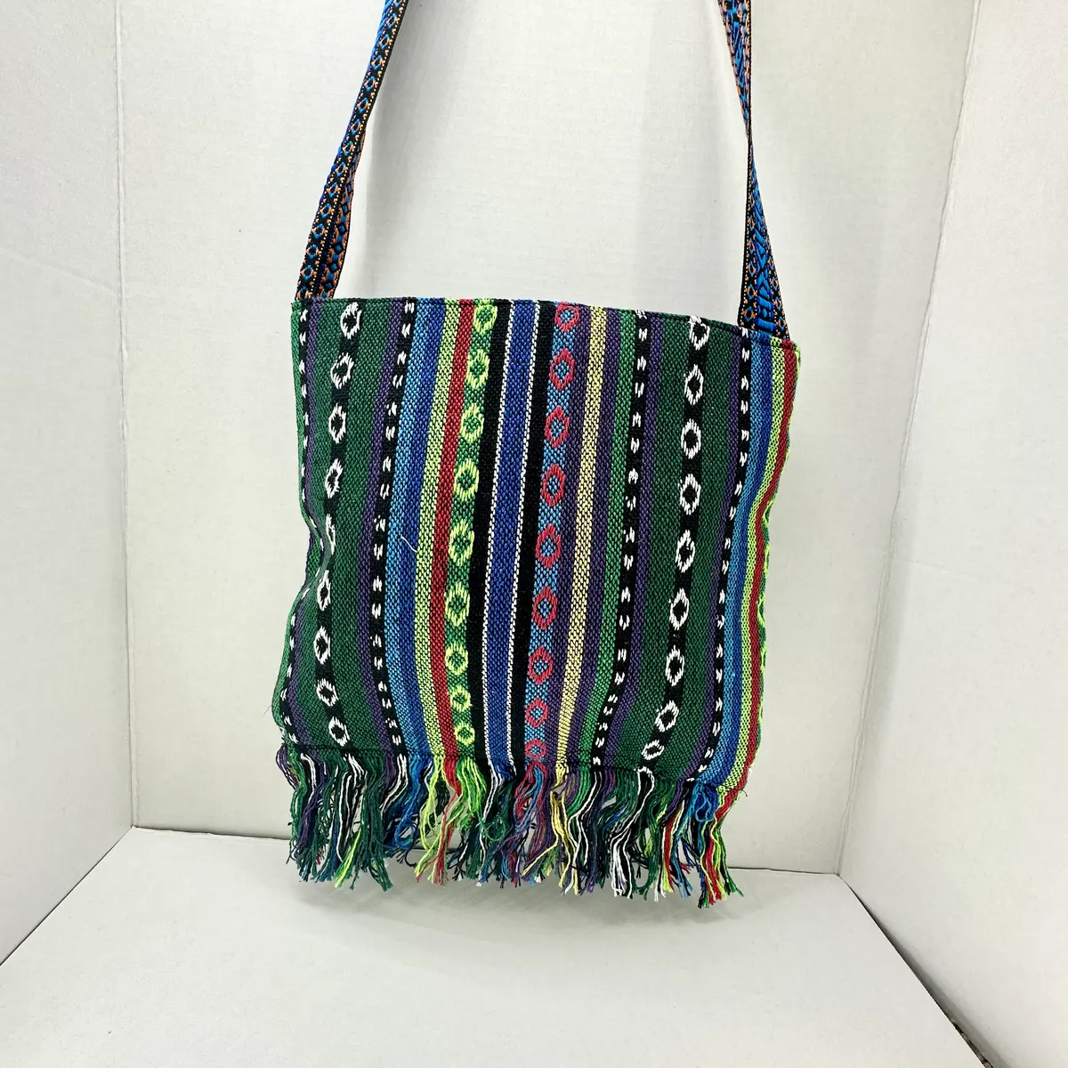 Green striped woven crossbody bag with fringe