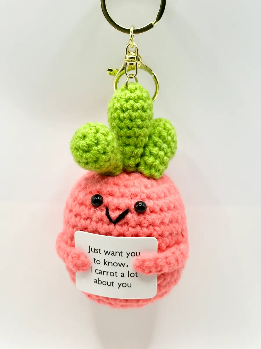 Pink crochet carrot keychain holding an I carrot a lot about you card